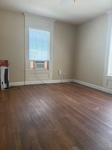 a view of wooden floor and windows in a room