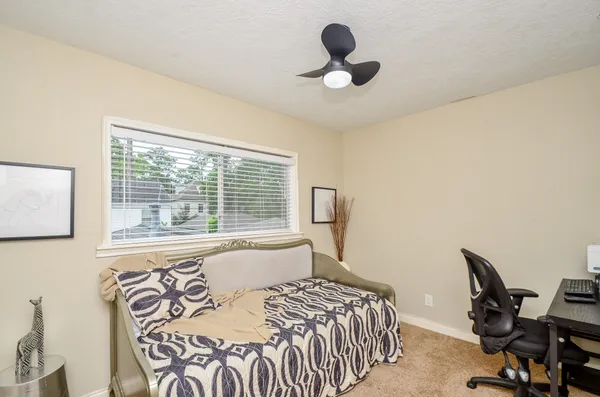 a bedroom with a bed and a window