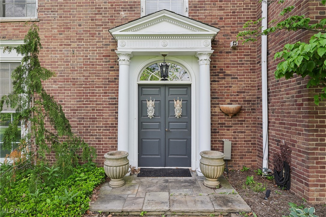 Property entrance featuring brick siding