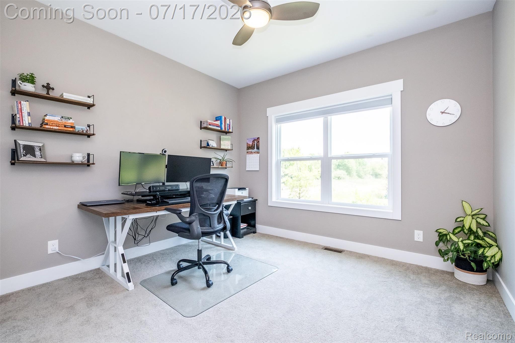 12349 Sugar Maple Drive Fenton, MI 48430 - Photo 34 of 67 Carpeted room featuring a large window, built-in shelving, a ceiling fan, and baseboard trim