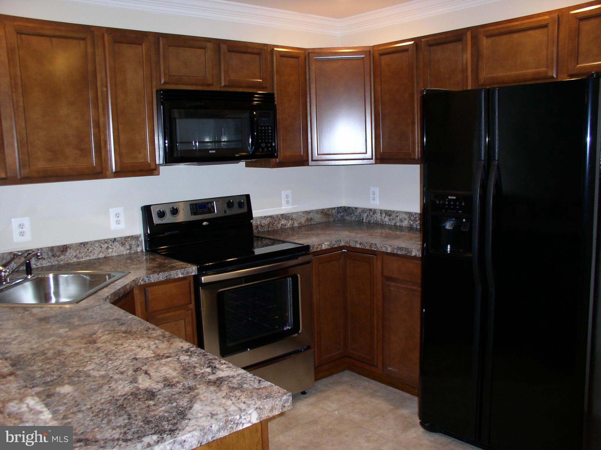 5910 A Sunlight Mountain Road, Unit A Spotsylvania, VA 22553 - Photo 3 of 24 a kitchen with a stove microwave and refrigerator