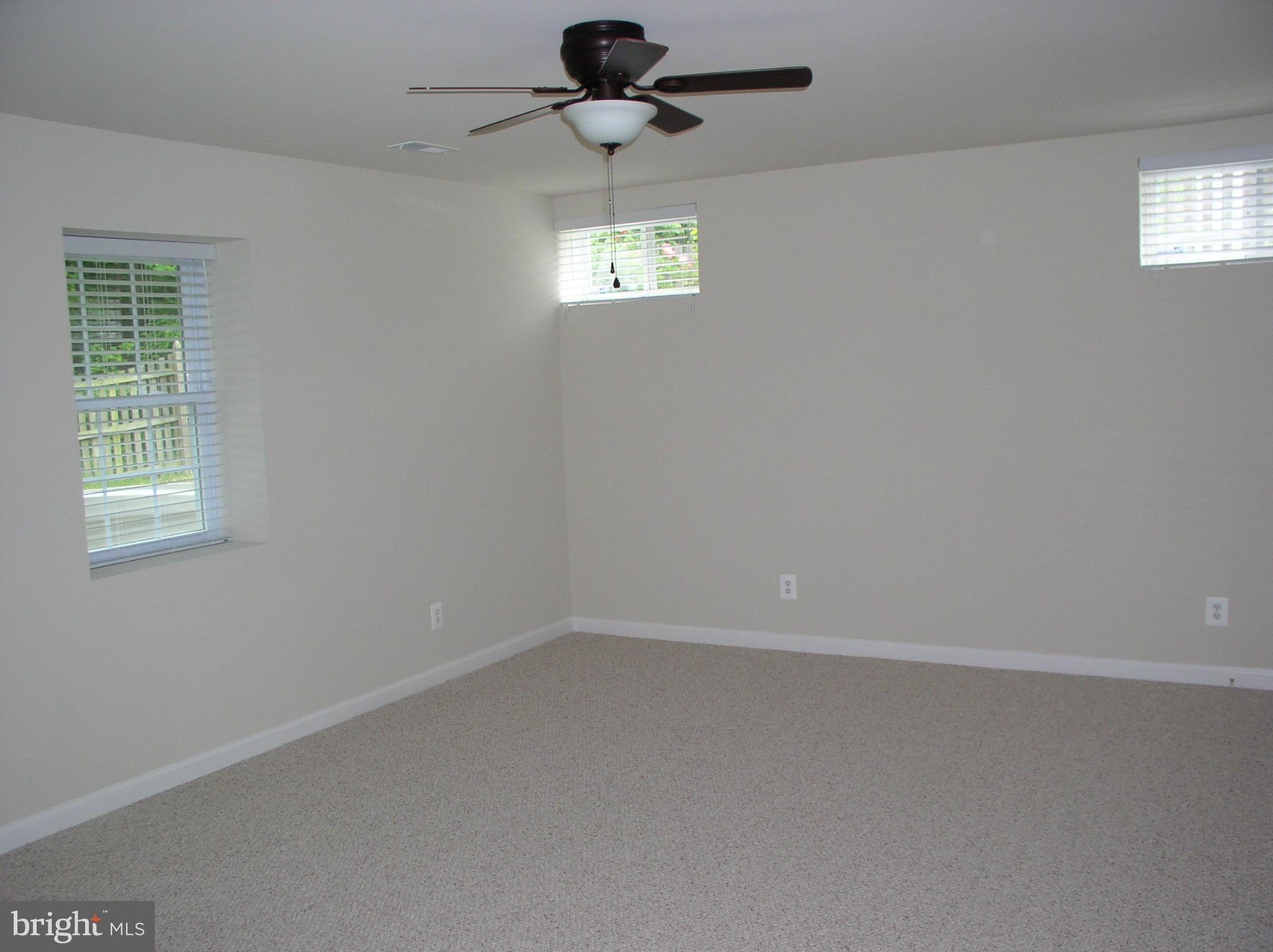 5910 A Sunlight Mountain Road, Unit A Spotsylvania, VA 22553 - Photo 9 of 24 an empty room with windows and fan