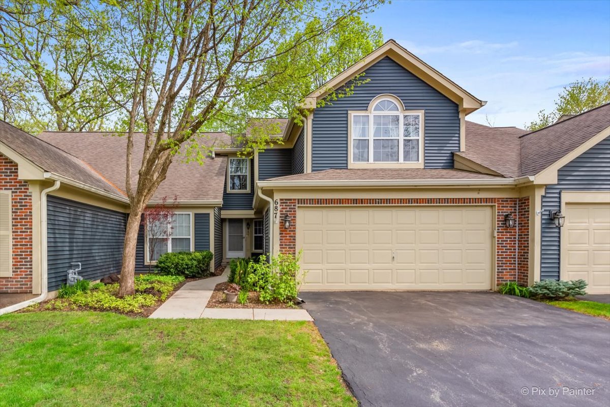 687 Bent Ridge Lane Elgin, IL 60120 - Photo 1 of 28 a front view of a house with a yard and garage