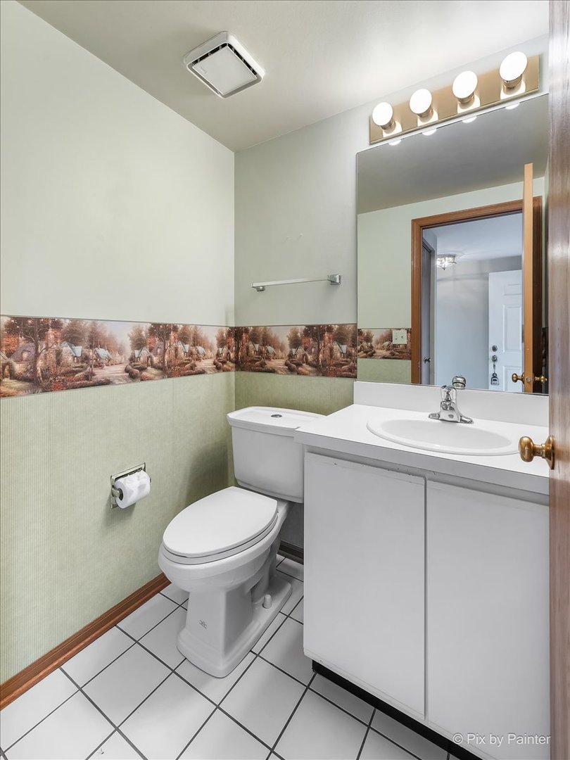 687 Bent Ridge Lane Elgin, IL 60120 - Photo 23 of 28 a bathroom with a toilet sink and mirror