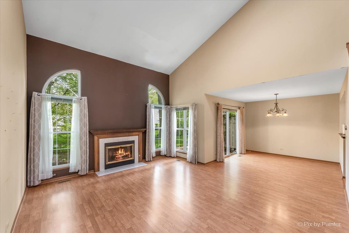 687 Bent Ridge Lane Elgin, IL 60120 - Photo 3 of 28 an empty room with windows fire place and a fireplace