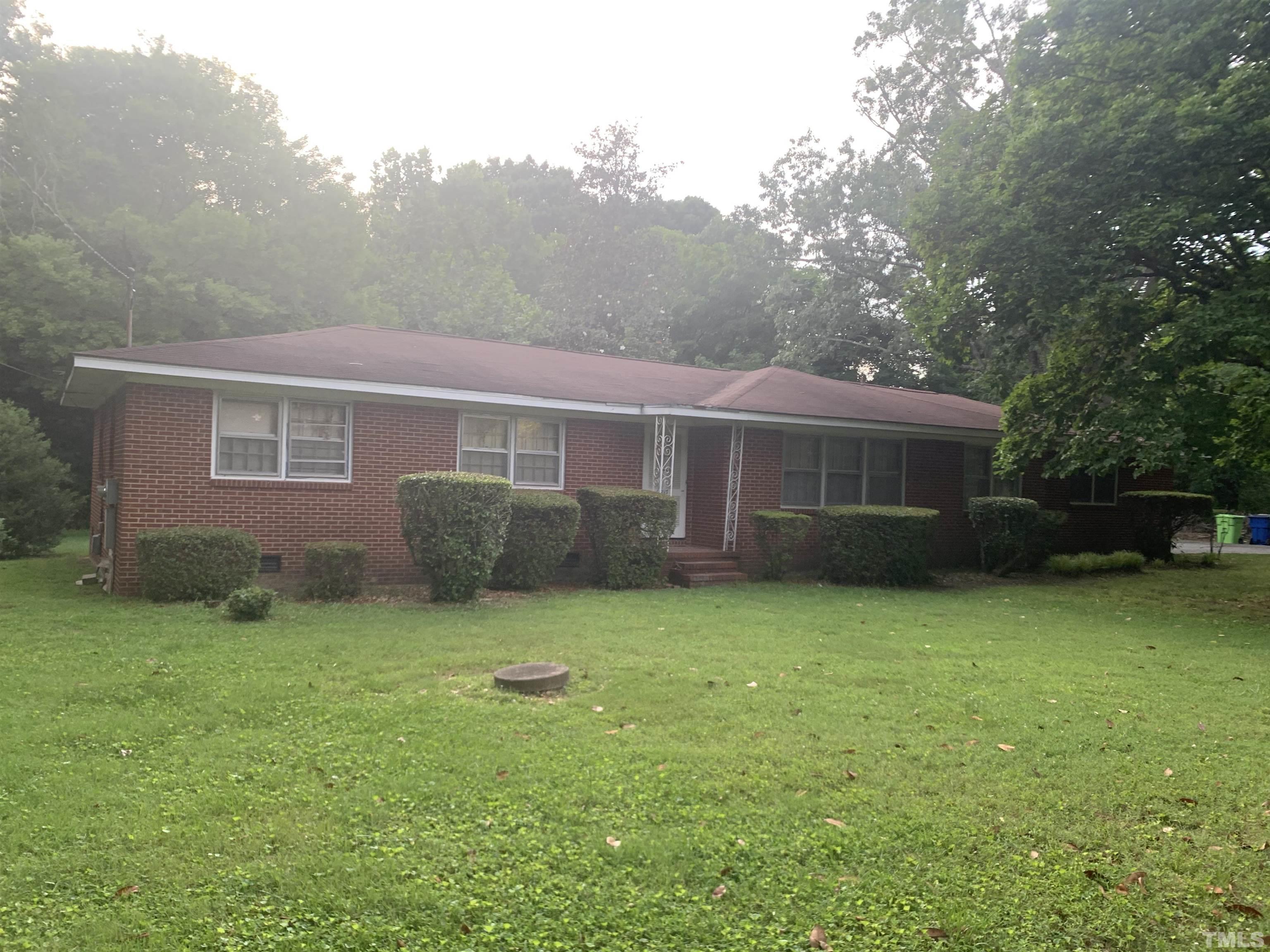 917 Cross Link Road Raleigh, NC 27610 - Photo 2 of 10 a backyard of a house with plants and large trees