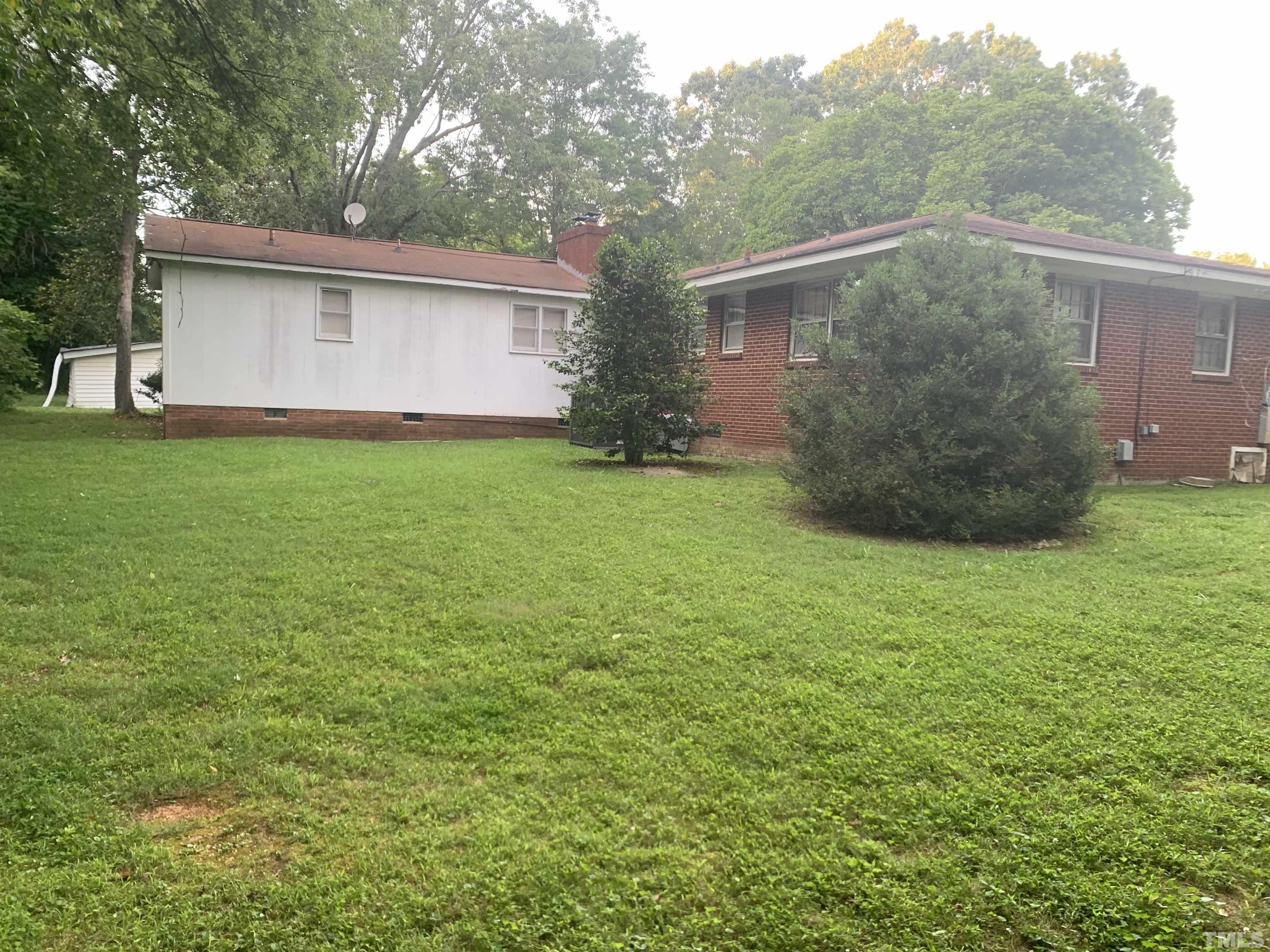 917 Cross Link Road Raleigh, NC 27610 - Photo 5 of 10 a backyard of a house with lots of green space