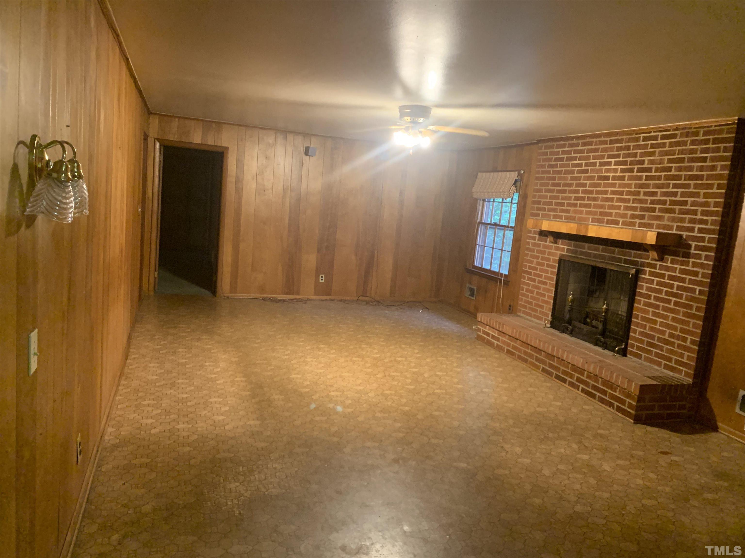 917 Cross Link Road Raleigh, NC 27610 - Photo 7 of 10 a view of empty room with a fireplace