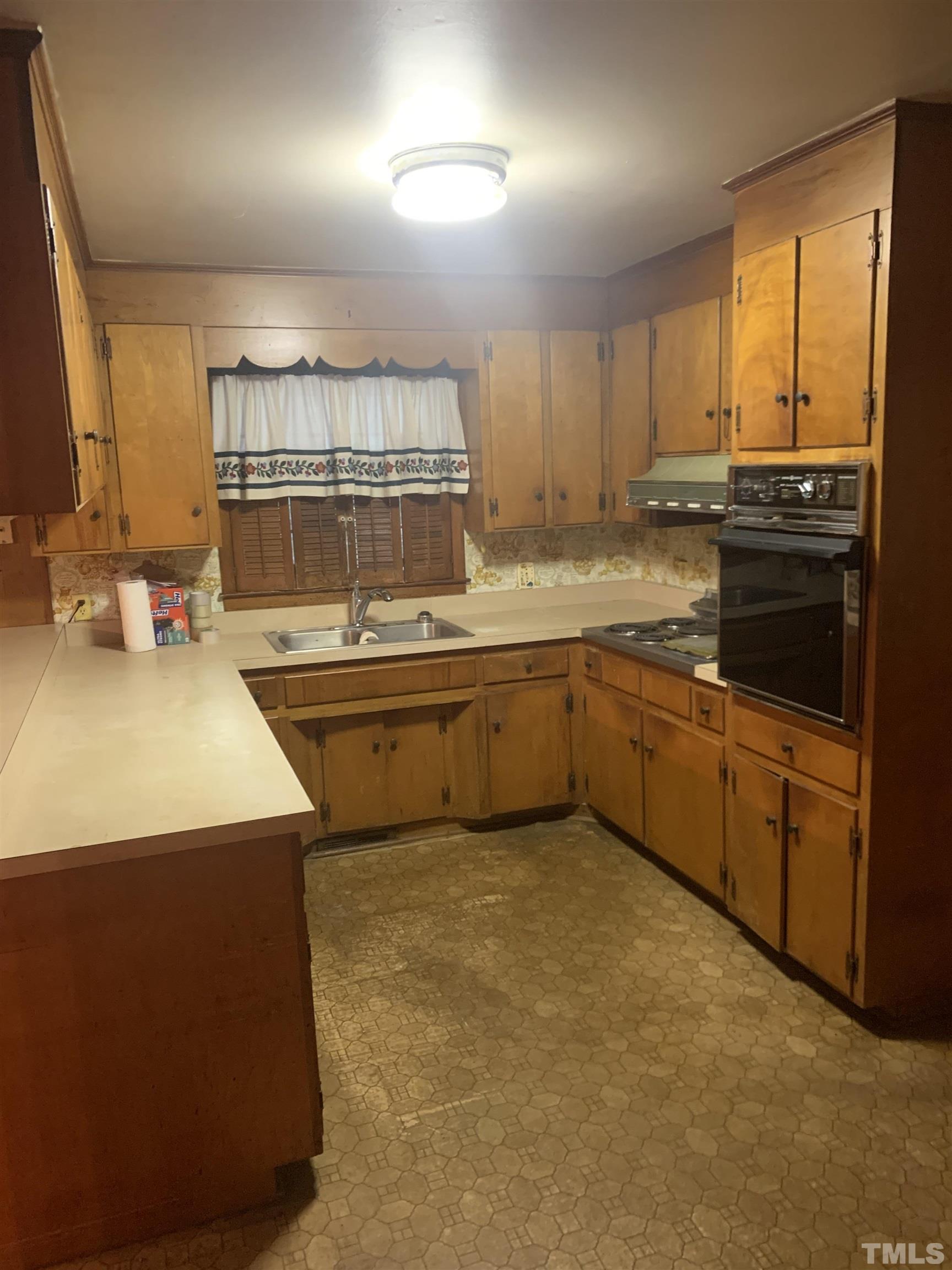 917 Cross Link Road Raleigh, NC 27610 - Photo 8 of 10 a kitchen with a sink stove and cabinets