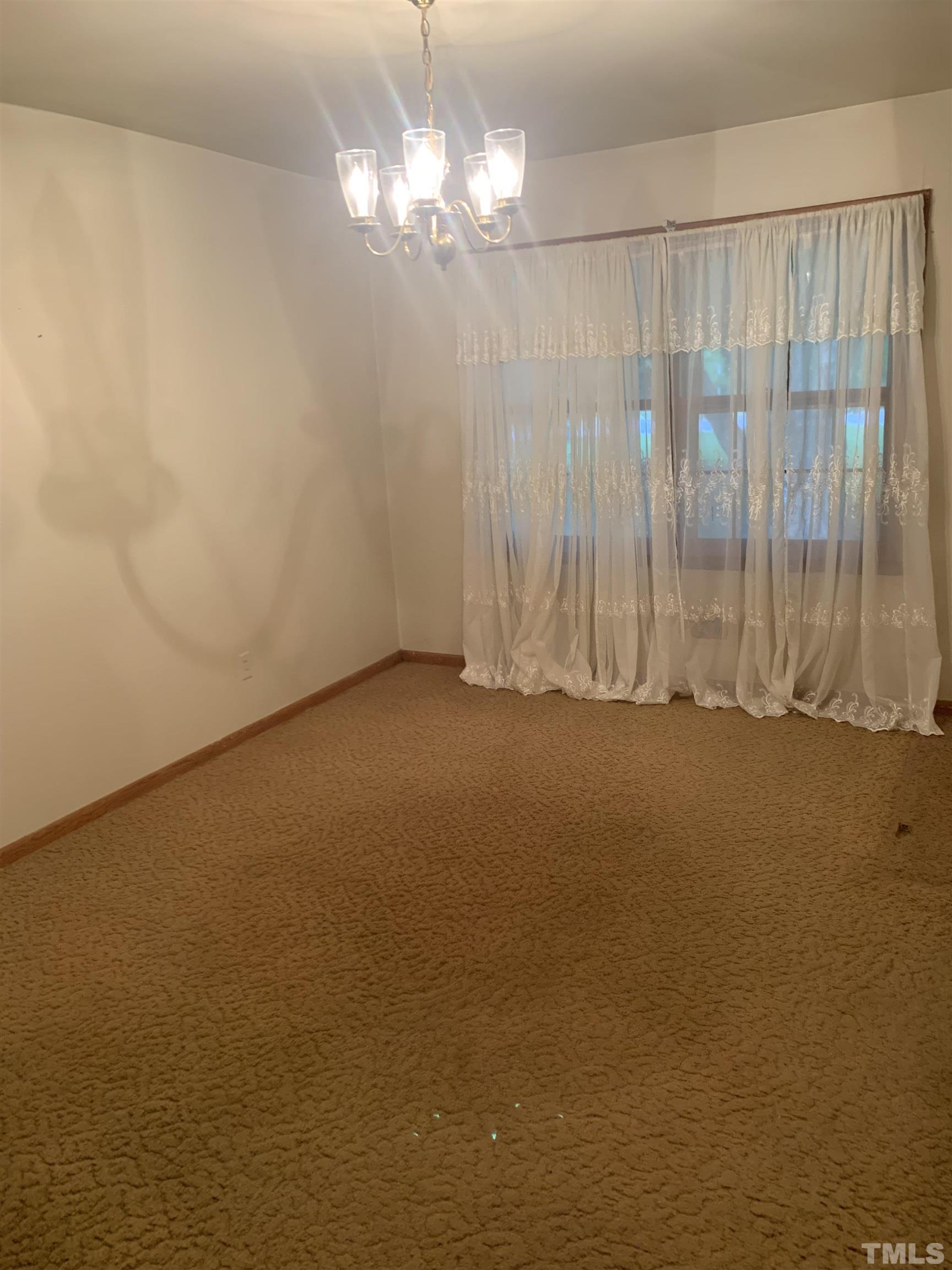 917 Cross Link Road Raleigh, NC 27610 - Photo 9 of 10 a view of an empty room with a window