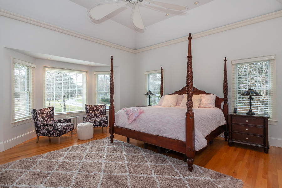 19 Reflection Drive Sandwich, MA 02563 - Photo 12 of 33 a bedroom with a bed and large windows