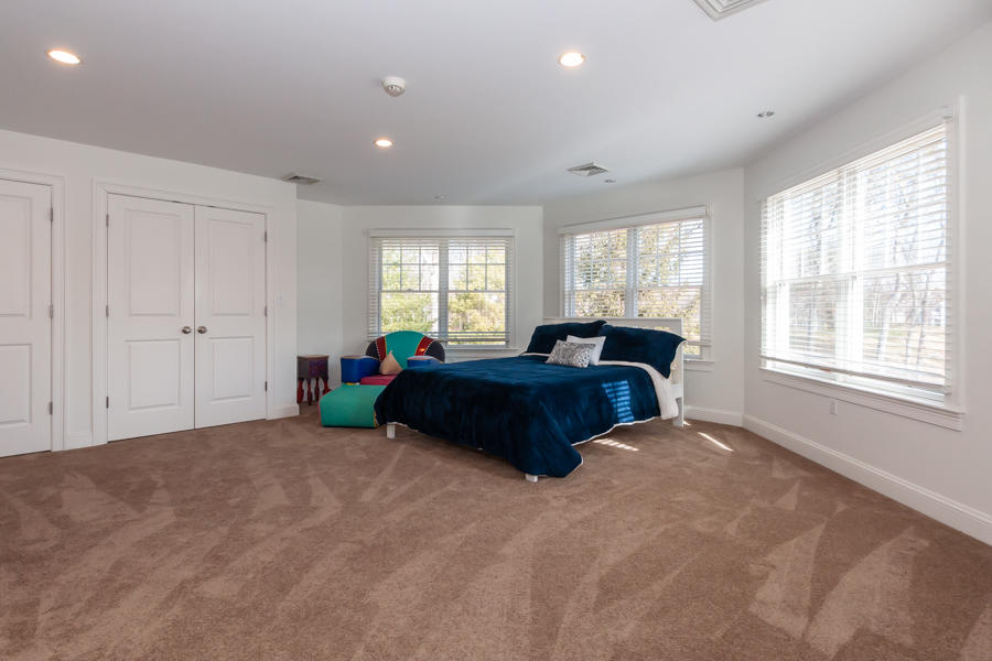 19 Reflection Drive Sandwich, MA 02563 - Photo 17 of 33 a large bedroom with a bed and a large window