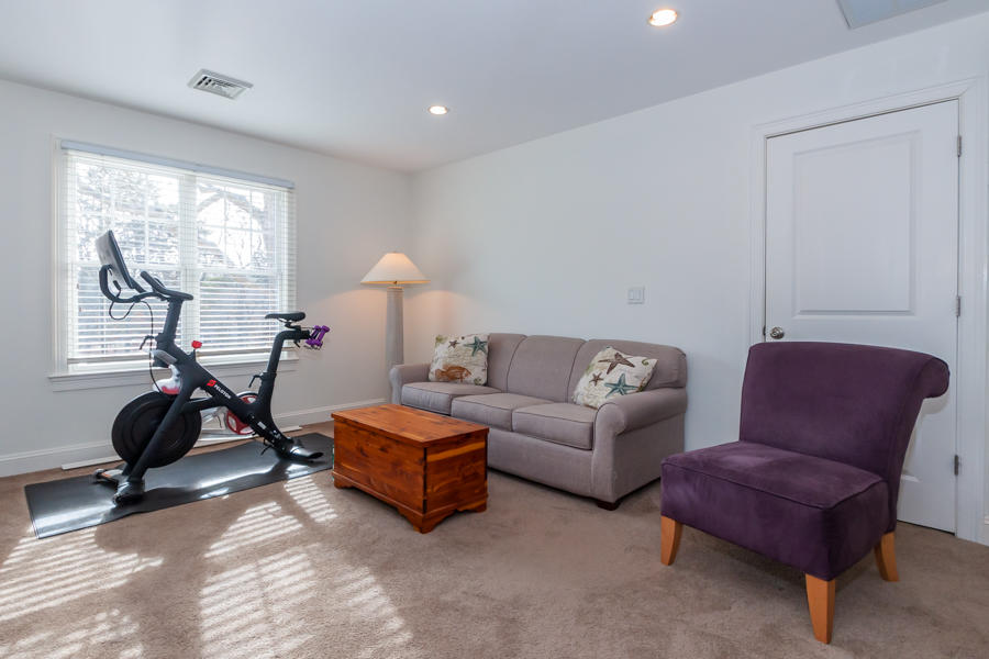 19 Reflection Drive Sandwich, MA 02563 - Photo 22 of 33 a living room with furniture a gym equipment and a large window