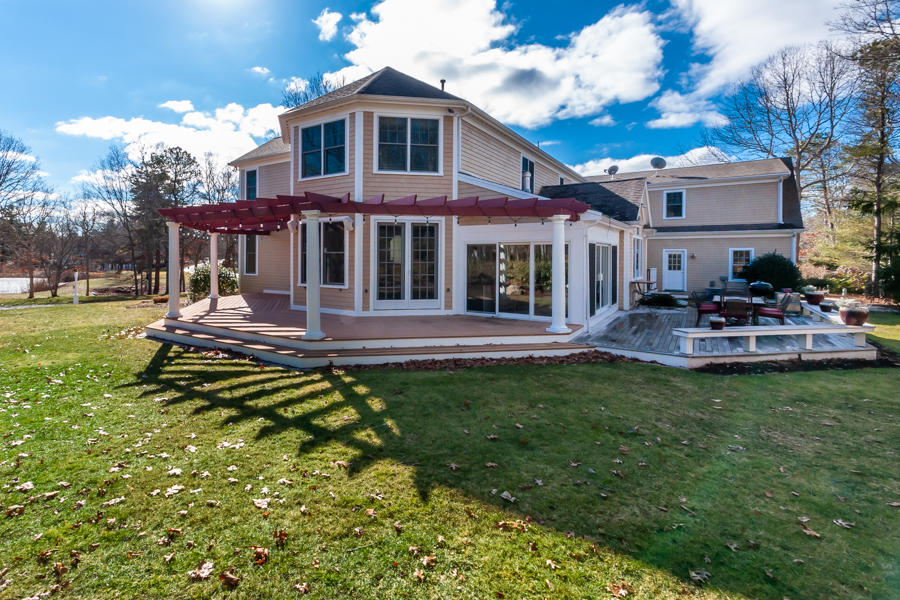 19 Reflection Drive Sandwich, MA 02563 - Photo 25 of 33 a view of a house with a yard patio and fire pit