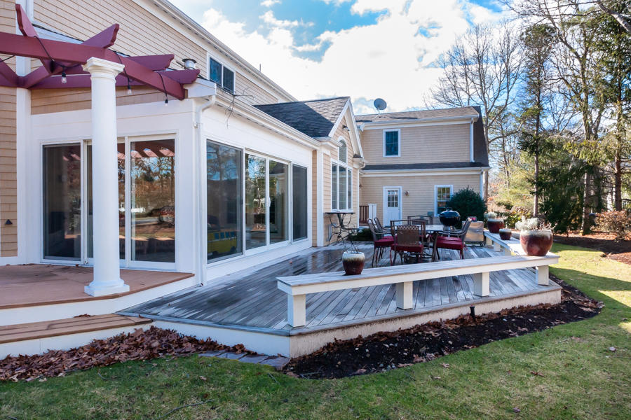 19 Reflection Drive Sandwich, MA 02563 - Photo 26 of 33 a view of a house with backyard porch and sitting area