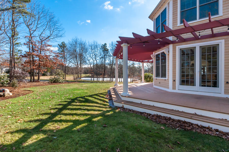 19 Reflection Drive Sandwich, MA 02563 - Photo 27 of 33 a view of a house with a yard patio and fire pit
