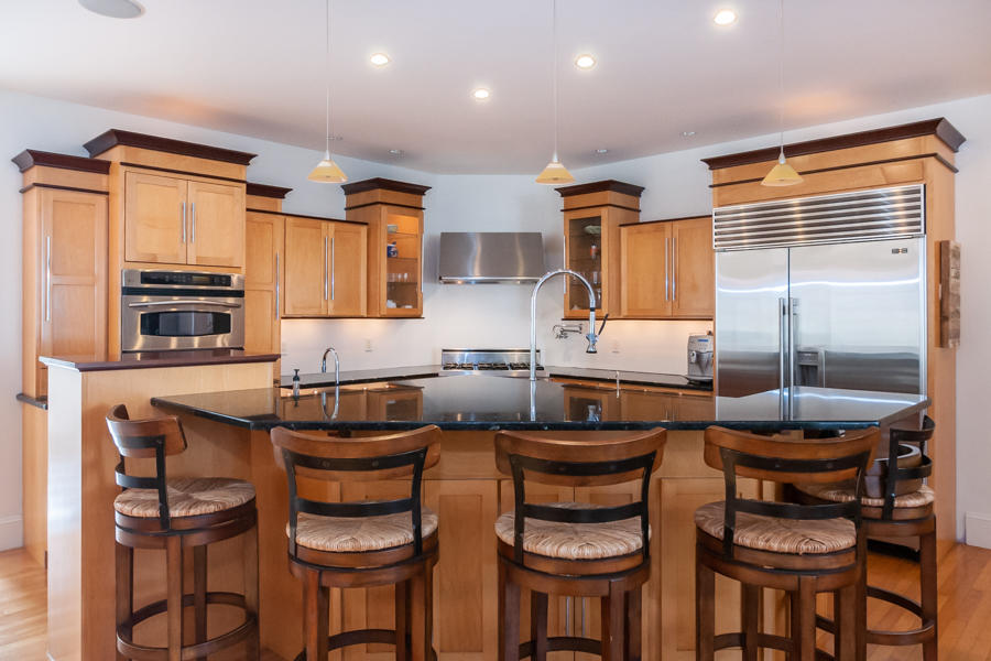 19 Reflection Drive Sandwich, MA 02563 - Photo 9 of 33 a kitchen with a refrigerator and cabinets