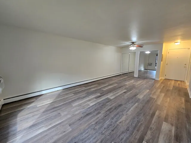 a view of an empty room and wooden floor