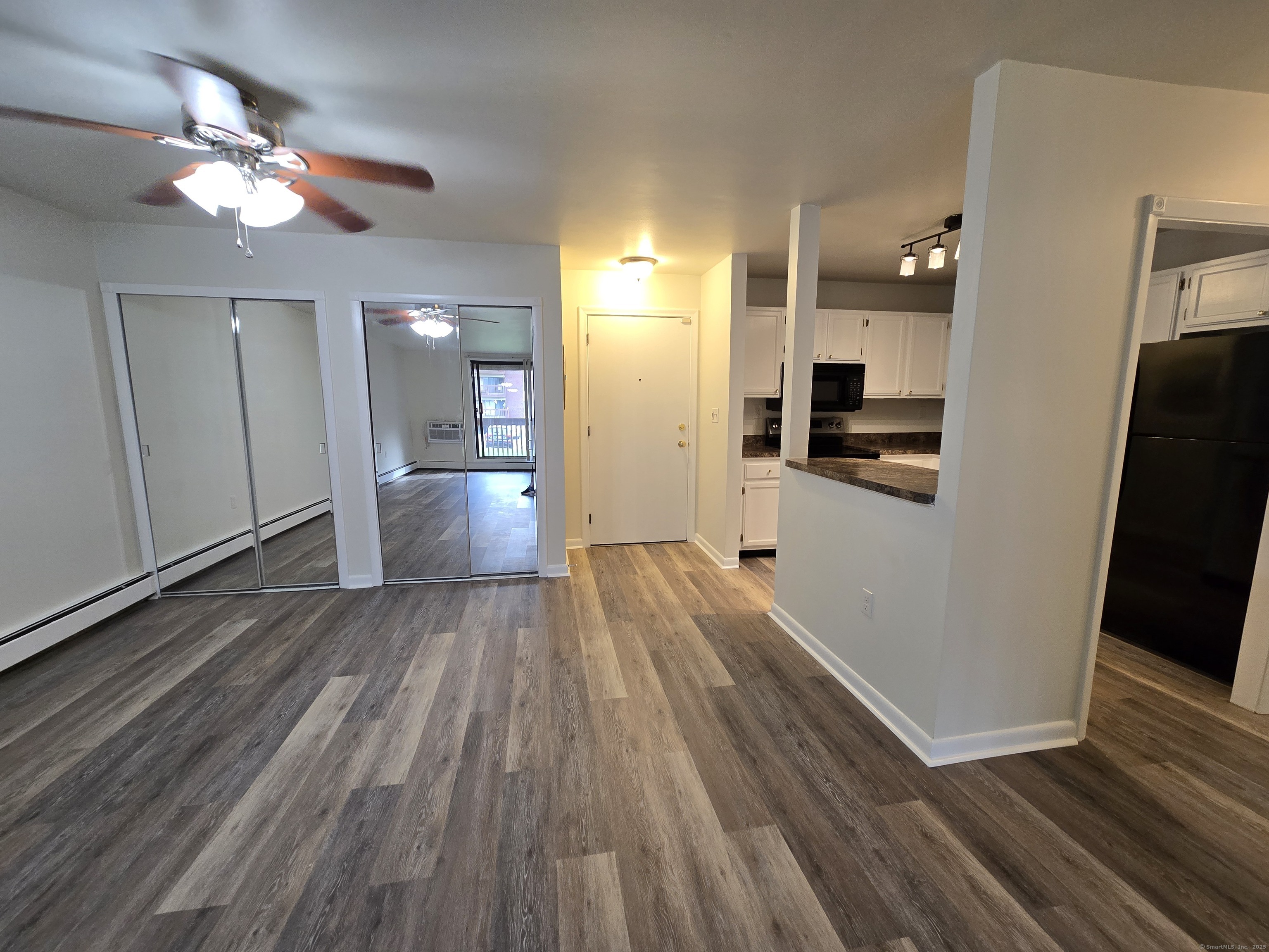 1209 Cromwell Hills Drive, Unit 1209 Cromwell, CT 06416 - Photo 13 of 27 a view of a kitchen from the hallway with a stove