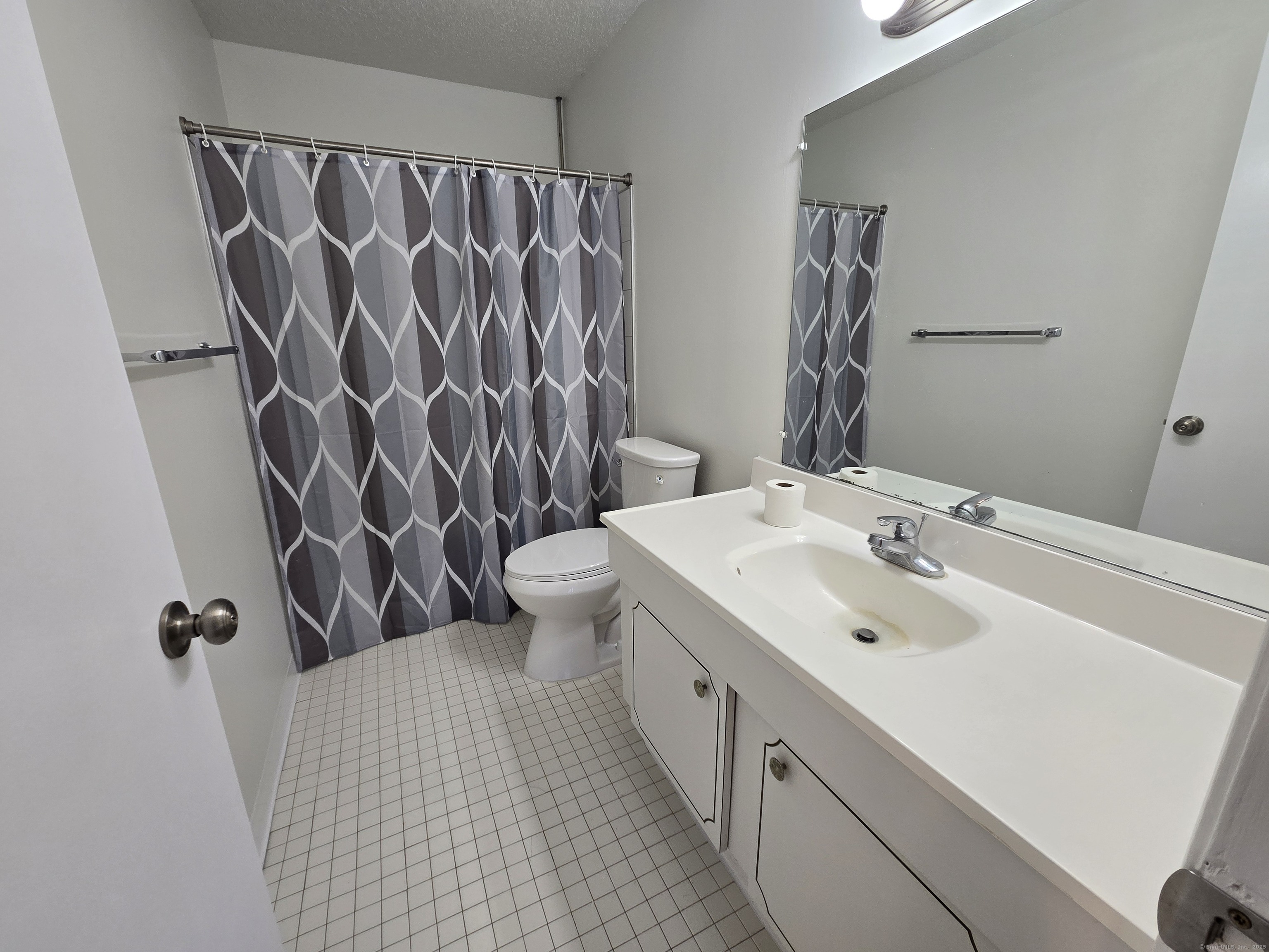 1209 Cromwell Hills Drive, Unit 1209 Cromwell, CT 06416 - Photo 15 of 27 a bathroom with a sink and mirror