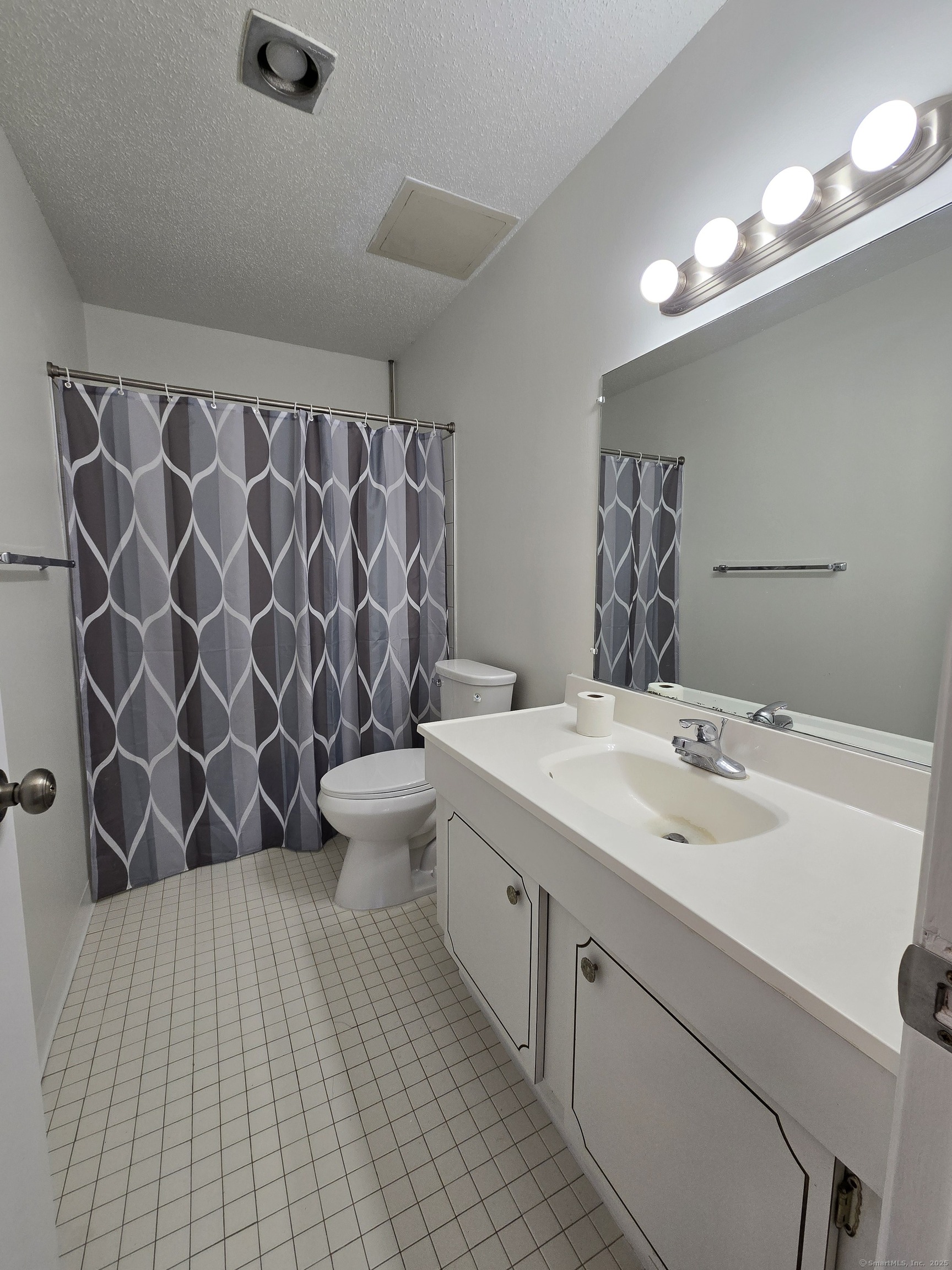 1209 Cromwell Hills Drive, Unit 1209 Cromwell, CT 06416 - Photo 16 of 27 a bathroom with a sink and mirror
