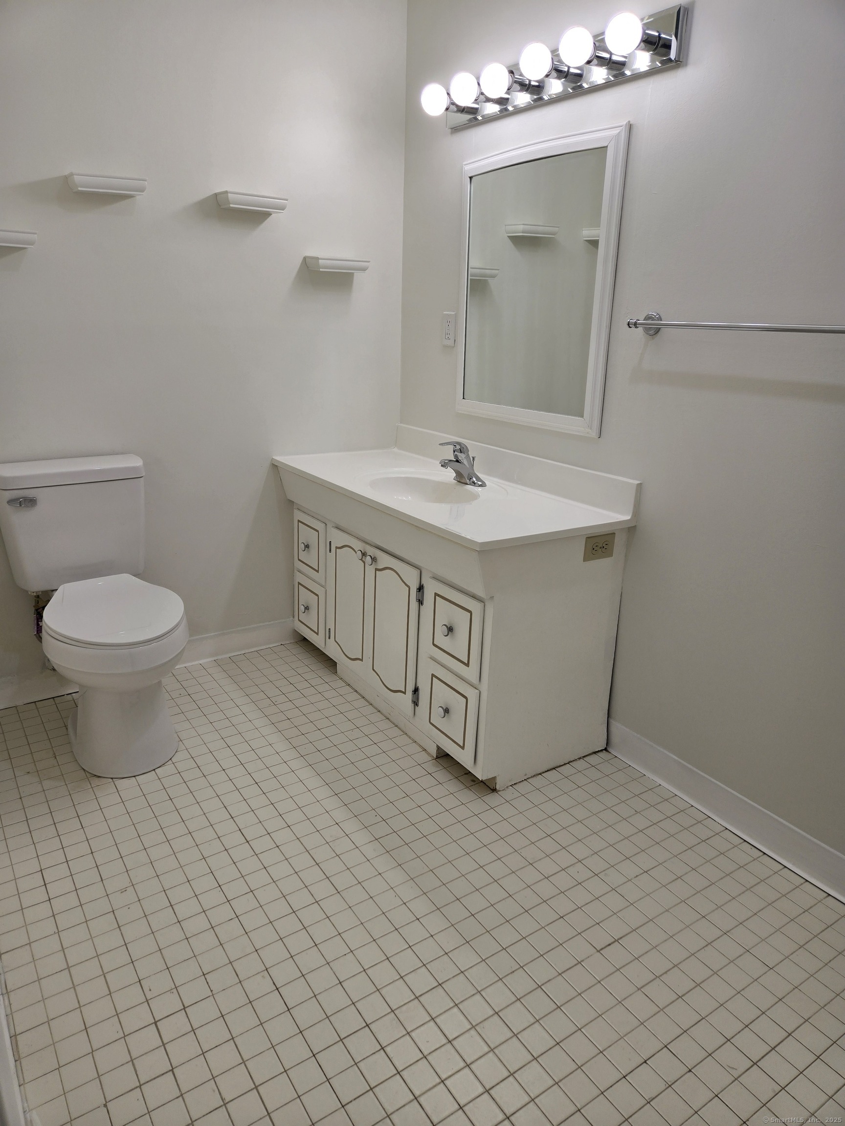 1209 Cromwell Hills Drive, Unit 1209 Cromwell, CT 06416 - Photo 18 of 27 a bathroom with a sink a toilet and mirror