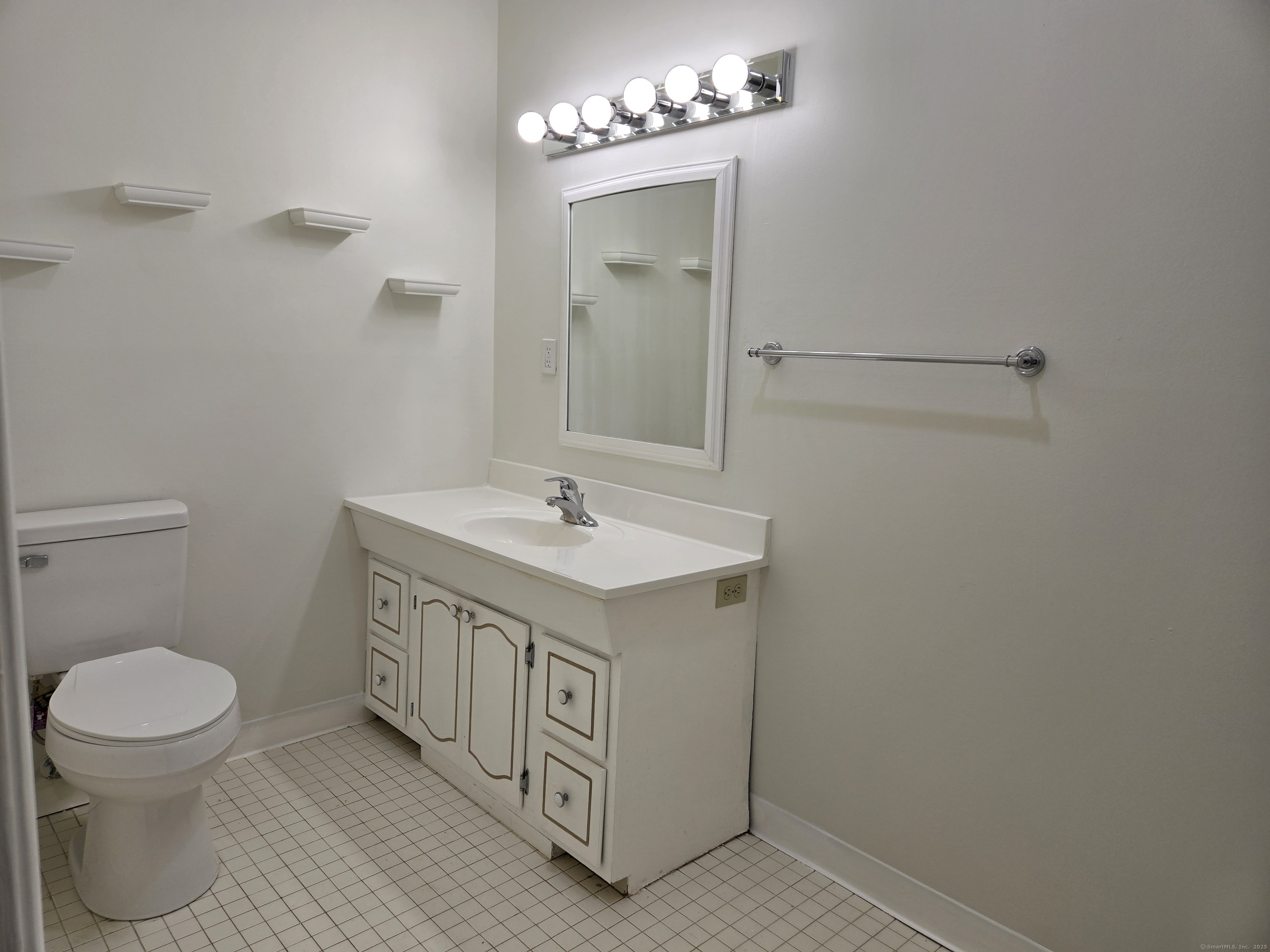 1209 Cromwell Hills Drive, Unit 1209 Cromwell, CT 06416 - Photo 19 of 27 a bathroom with a sink a toilet and a mirror