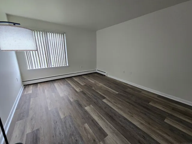 a view of an empty room and wooden floor