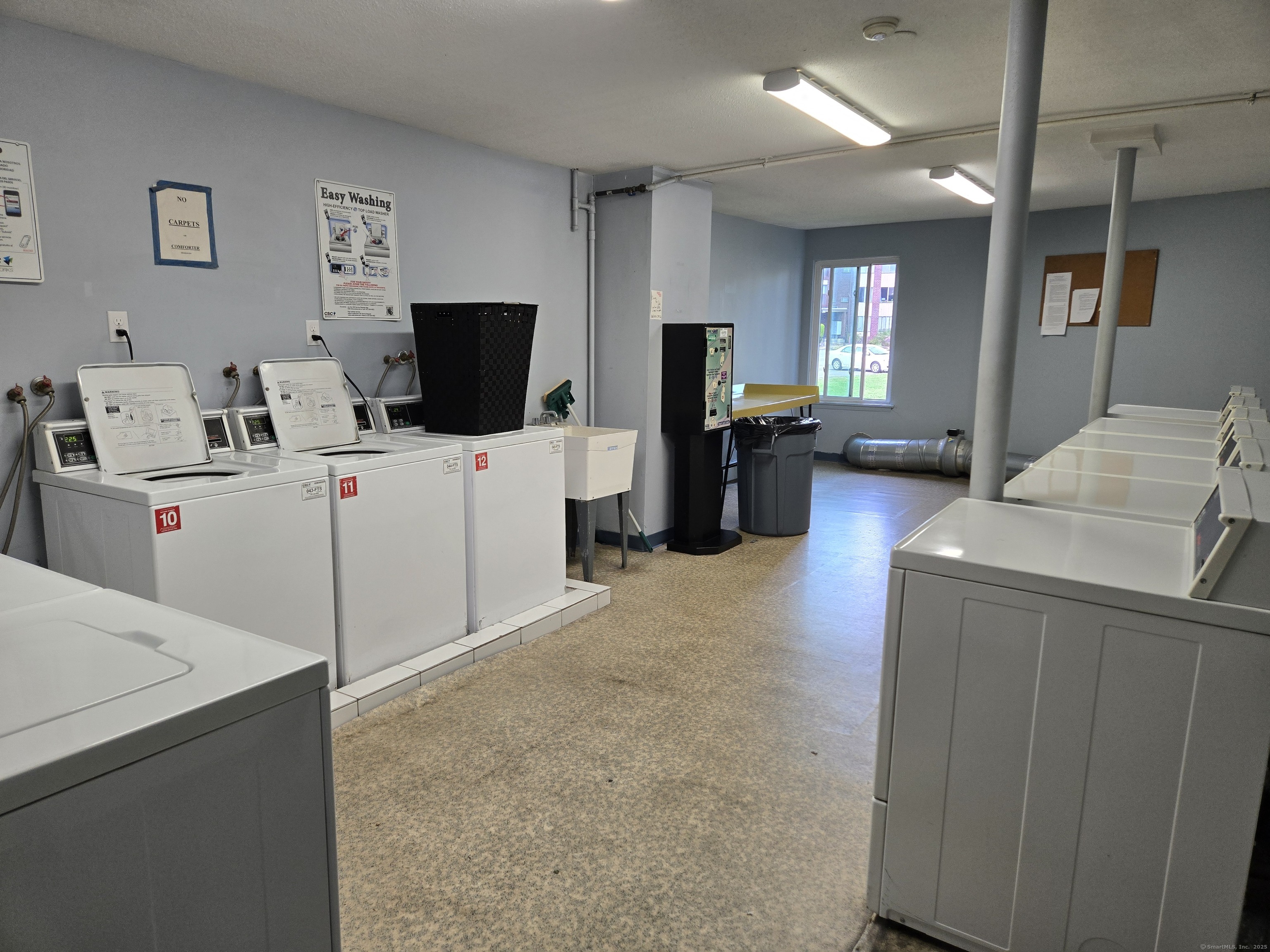 1209 Cromwell Hills Drive, Unit 1209 Cromwell, CT 06416 - Photo 24 of 27 a living room with furniture and a flat screen tv