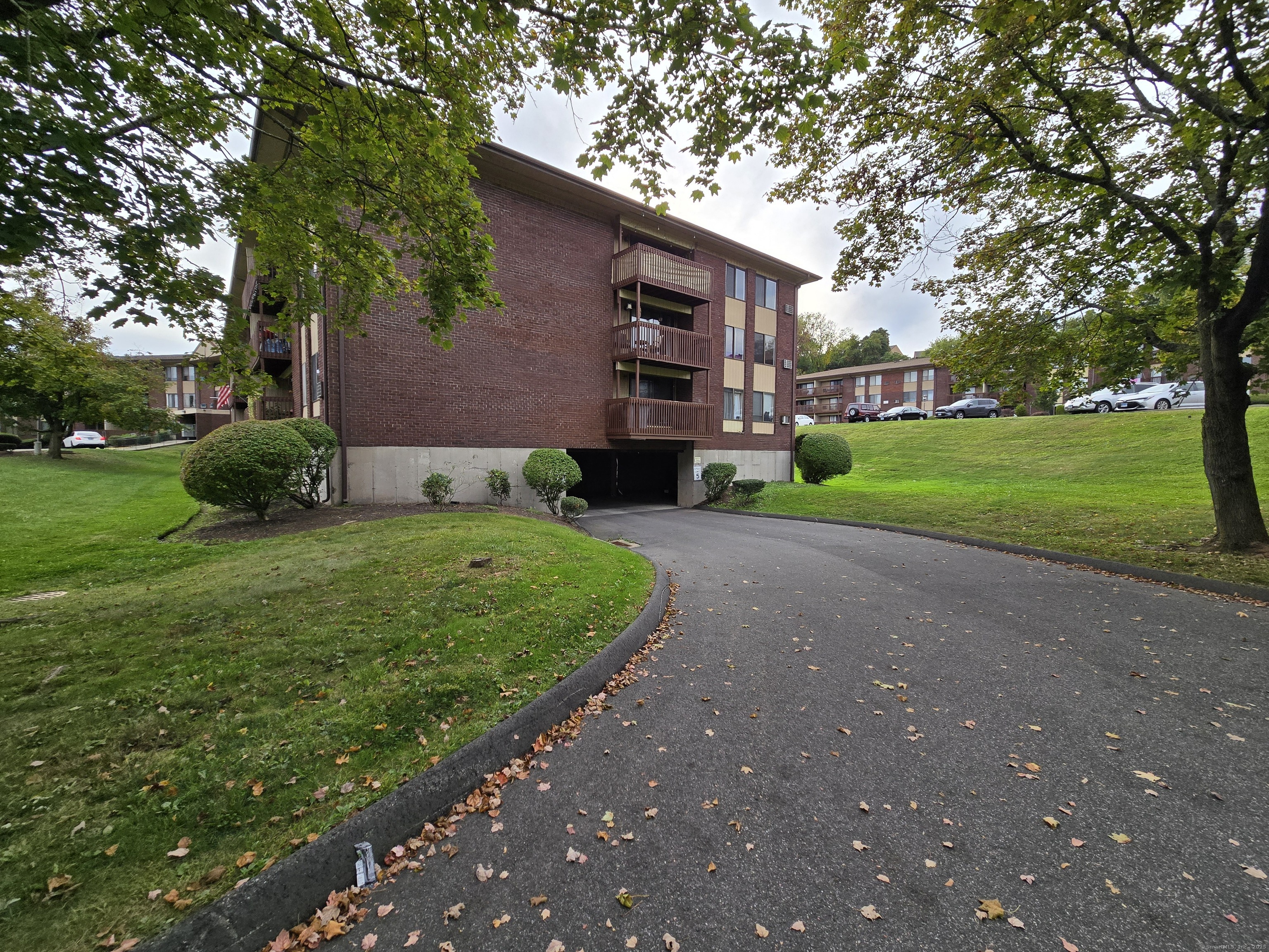 1209 Cromwell Hills Drive, Unit 1209 Cromwell, CT 06416 - Photo 25 of 27 a view of a house with a back yard