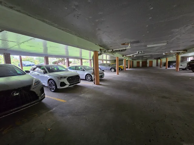 a living room with furniture a flat screen tv and a large window