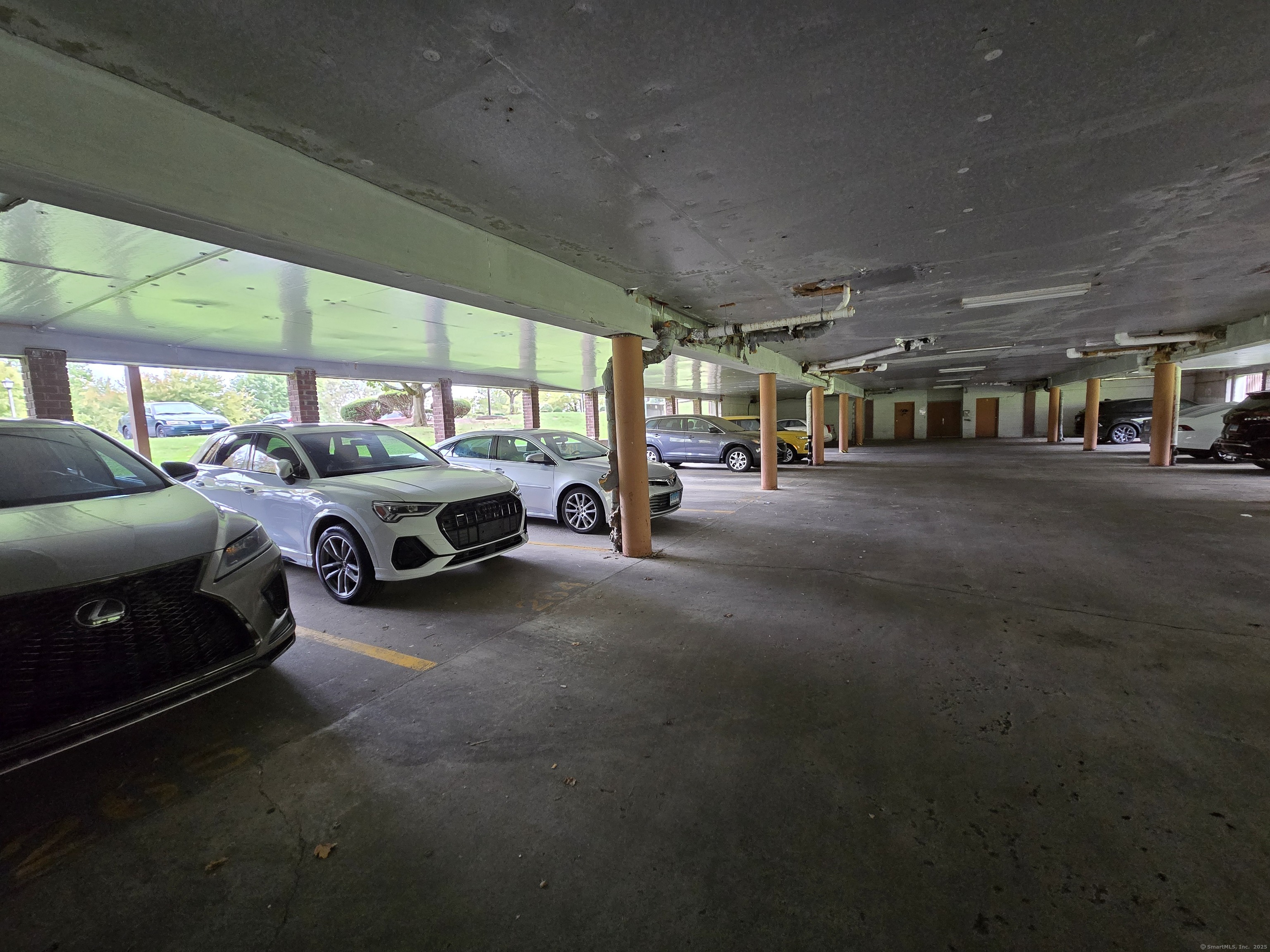 1209 Cromwell Hills Drive, Unit 1209 Cromwell, CT 06416 - Photo 26 of 27 a living room with furniture a flat screen tv and a large window