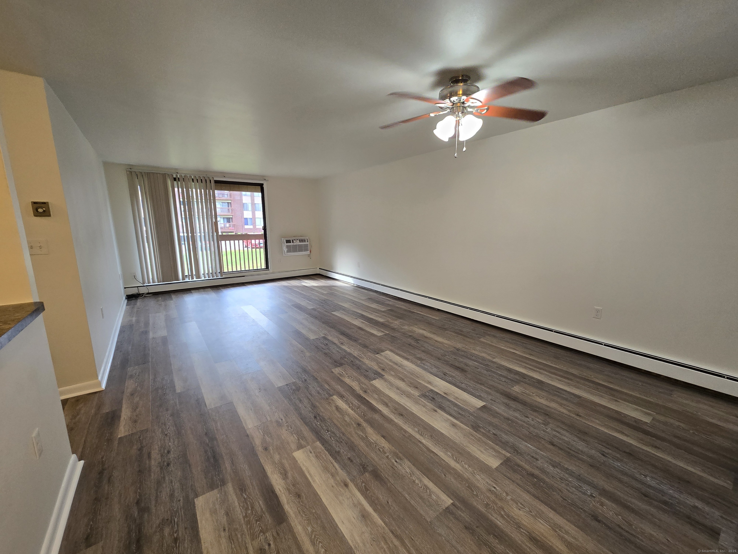 1209 Cromwell Hills Drive, Unit 1209 Cromwell, CT 06416 - Photo 9 of 27 wooden floor in an empty room with a window