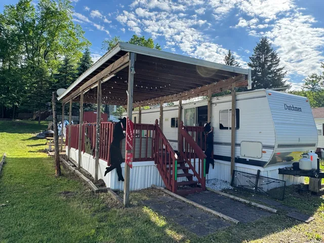 a view of a backyard with a patio and deck