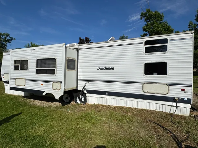 a view of a backyard with wooden fence