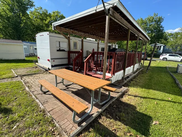 a view of a backyard with chairs and a patio