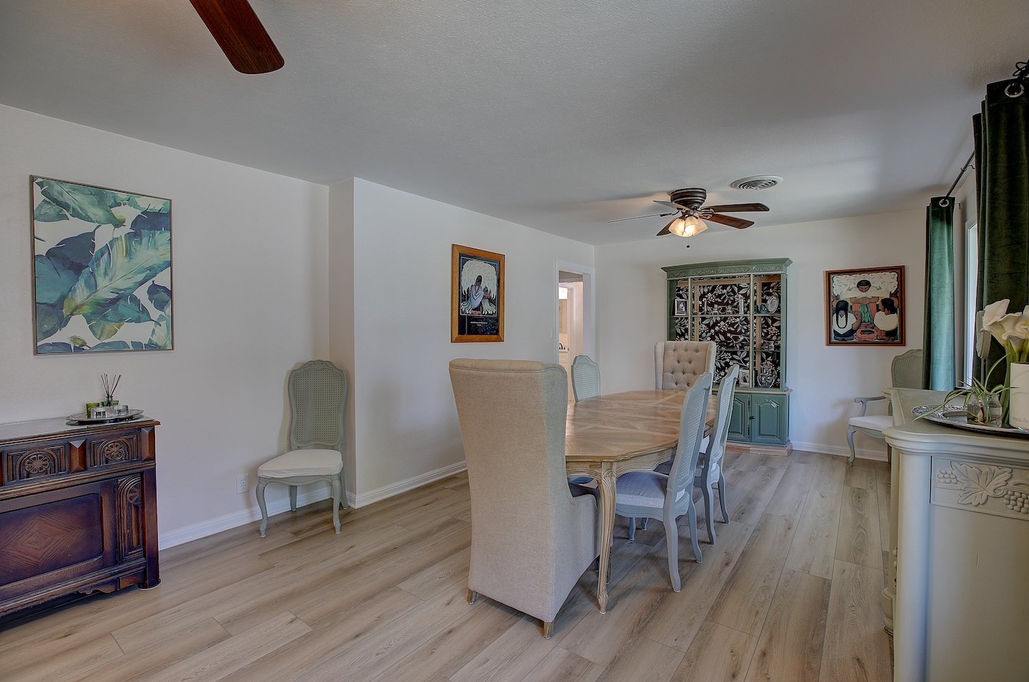 1902 East 18th Street Georgetown, TX 78626 - Photo 13 of 40 Formal Dining room has gorgeous wood look flooring, windows bring natural light, and could be used a flex space/ office/den/homework space
