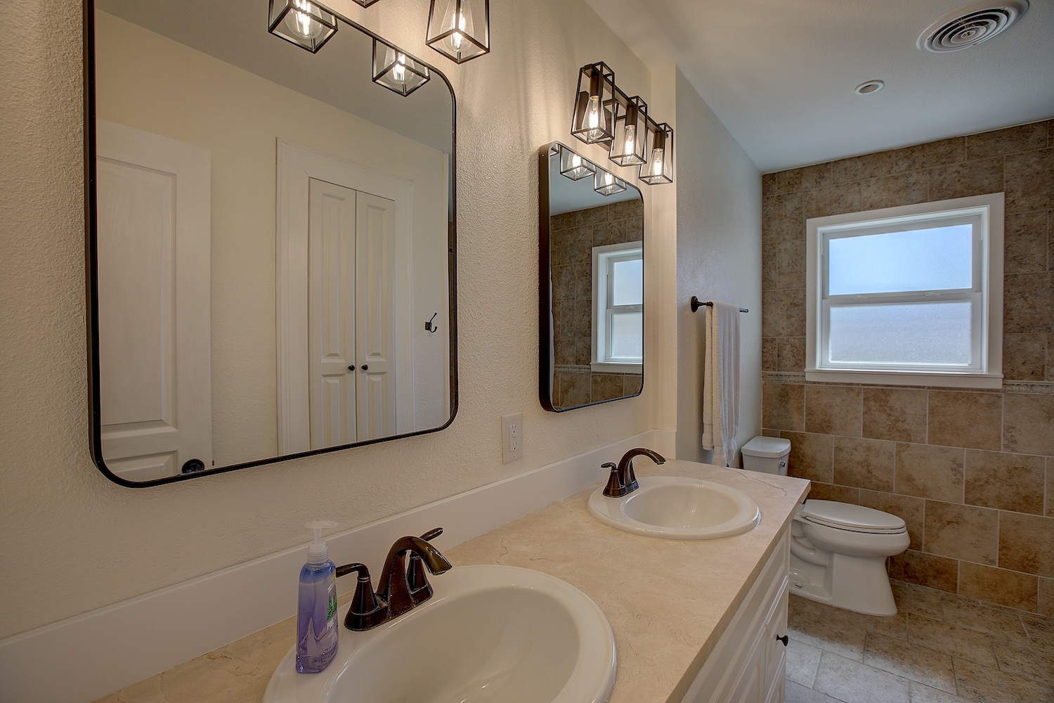 1902 East 18th Street Georgetown, TX 78626 - Photo 29 of 40 Bathroom #2, located in the hallway features dual vanity, super sized storage area. Recently installed cast iron tub, and tile surround