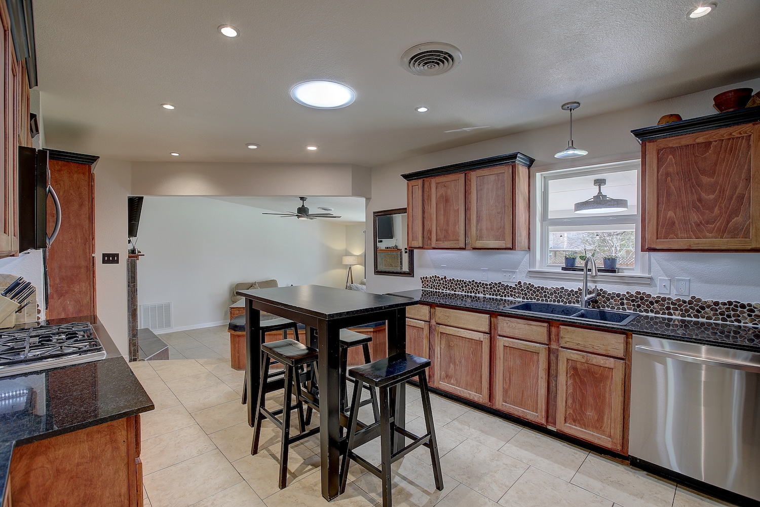 1902 East 18th Street Georgetown, TX 78626 - Photo 8 of 40 Kitchen featuring stainless steel appliances, Solar tub light, granite counters, wood grain cabinets