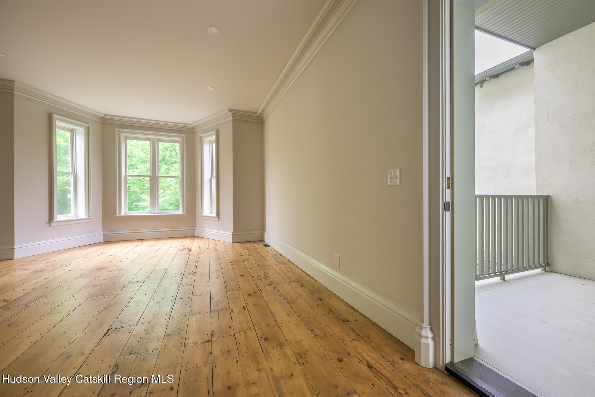 59 Allen Street Hudson, NY 12534 - Photo 16 of 59 a view of an empty room with wooden floor and a window