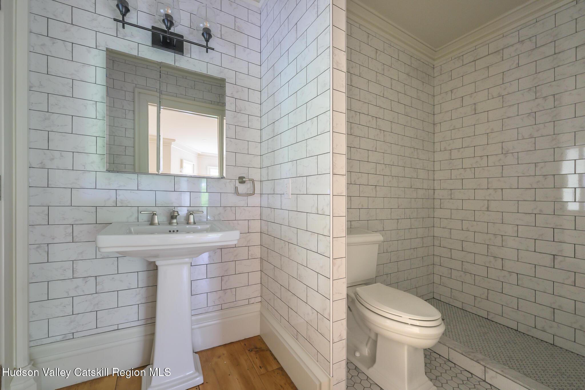 59 Allen Street Hudson, NY 12534 - Photo 35 of 59 a bathroom with a sink a toilet and mirror