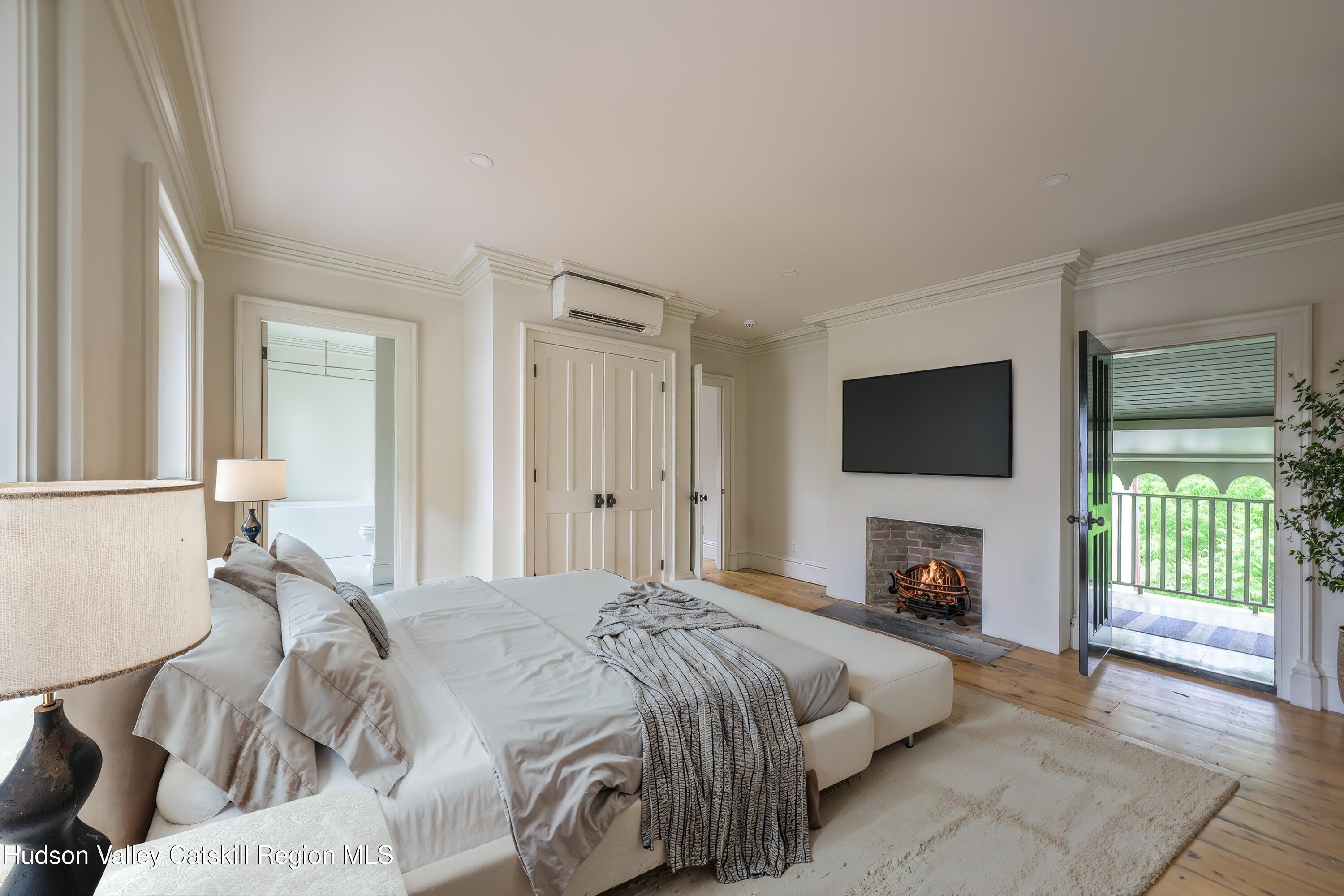 59 Allen Street Hudson, NY 12534 - Photo 37 of 59 a spacious bedroom with a bed and a television