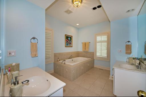 5662 South County Line Road Hinsdale, IL 60521 - Photo 11 of 16 a bathroom with a tub a sink and mirror