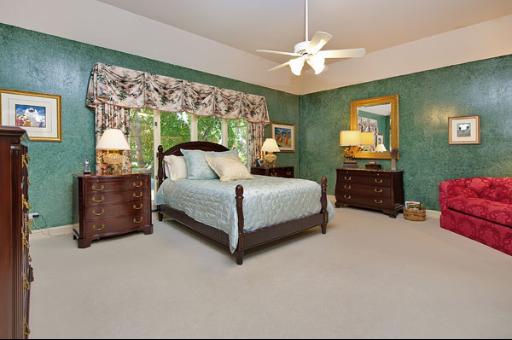 5662 South County Line Road Hinsdale, IL 60521 - Photo 7 of 16 a bedroom with a bed chandelier and window