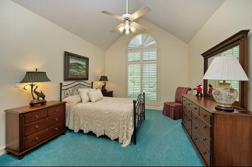 5662 South County Line Road Hinsdale, IL 60521 - Photo 10 of 16 a bedroom with a bed and a chandelier