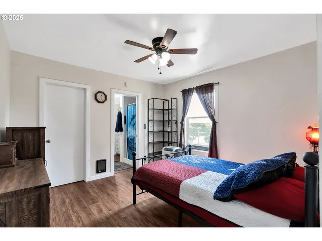 a bedroom with a bed and a large window