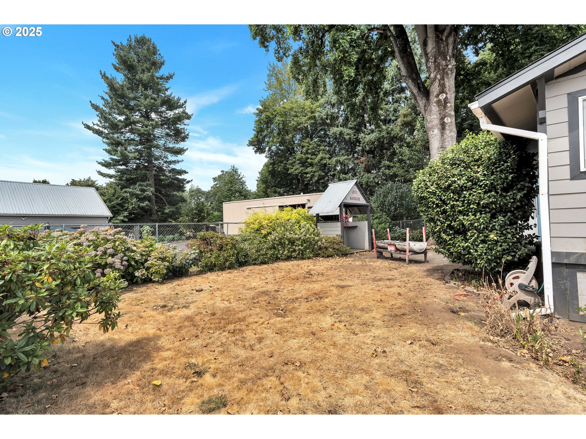 761 Southeast Polk Street Camas, WA 98607 - Photo 32 of 40 a yellow house with trees in front of it