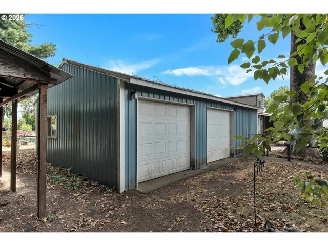 a backyard of a house with table and chairs