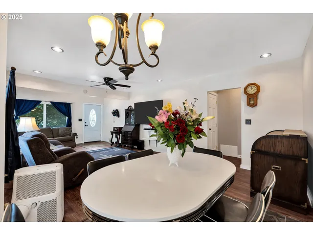 a living room with furniture flowers and a chandelier