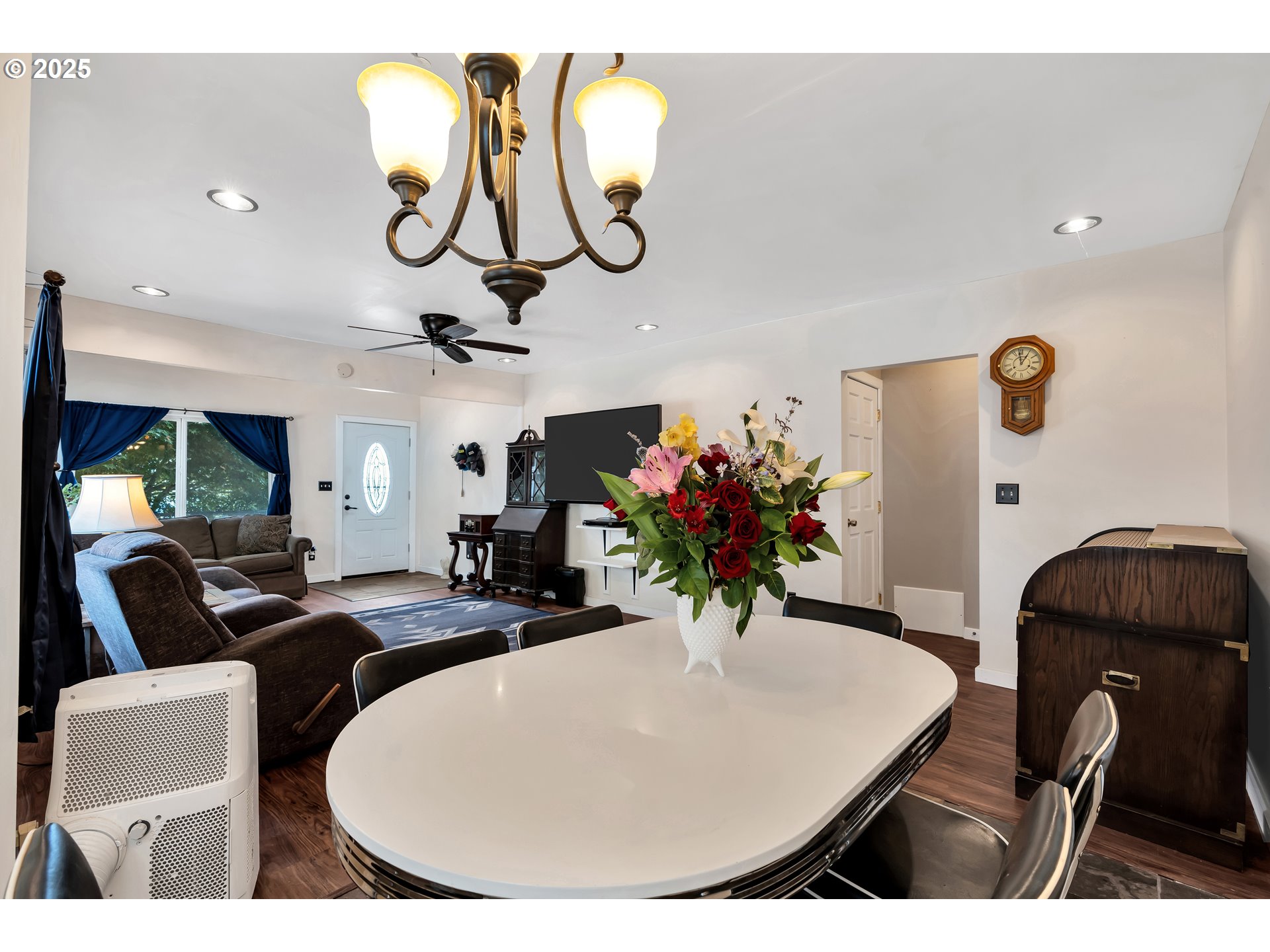 761 Southeast Polk Street Camas, WA 98607 - Photo 10 of 40 a living room with furniture flowers and a chandelier